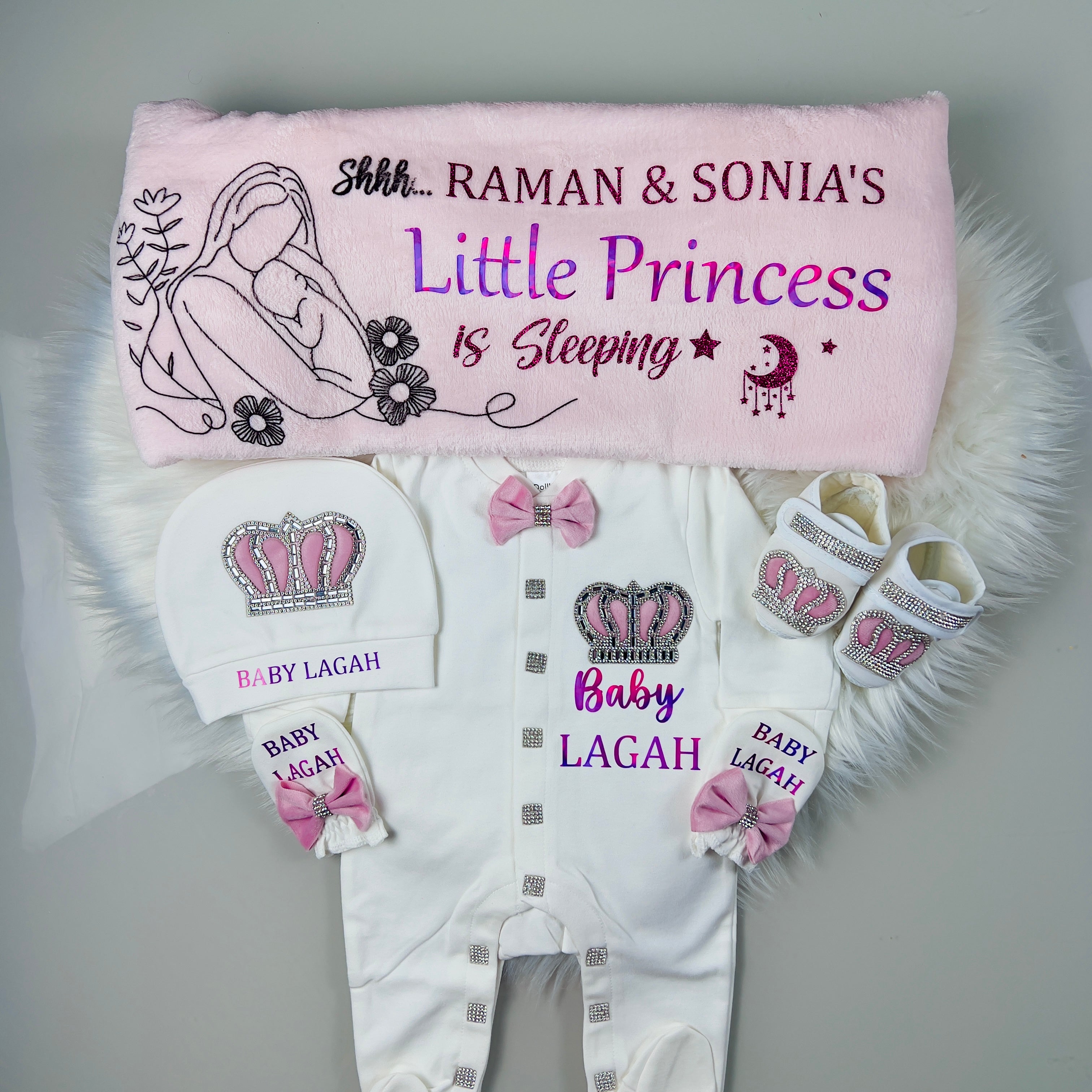 Baby clothing set with personalized items on a gray background