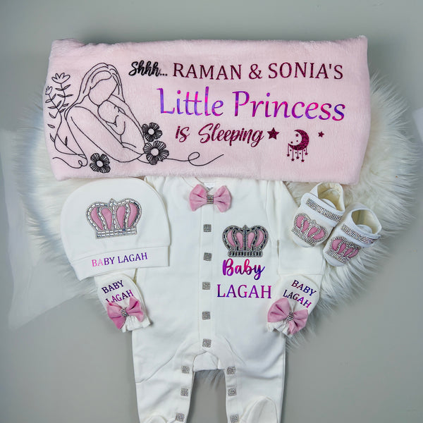 Baby clothing set with personalized items on a gray background